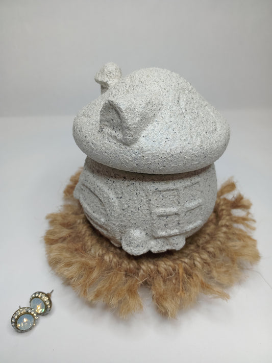 Decorative concrete mushroom trinket house with a stone textured surface and natural fiber on a white background